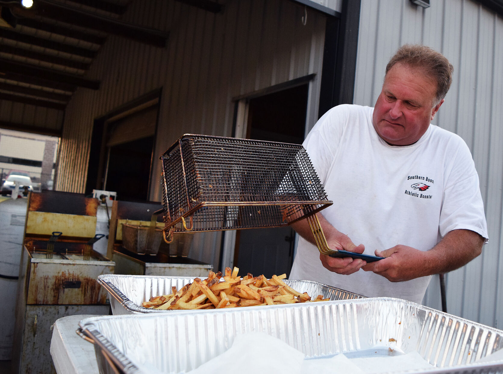 Jeff Knierim prepares fries before the Southern Boone Eagles